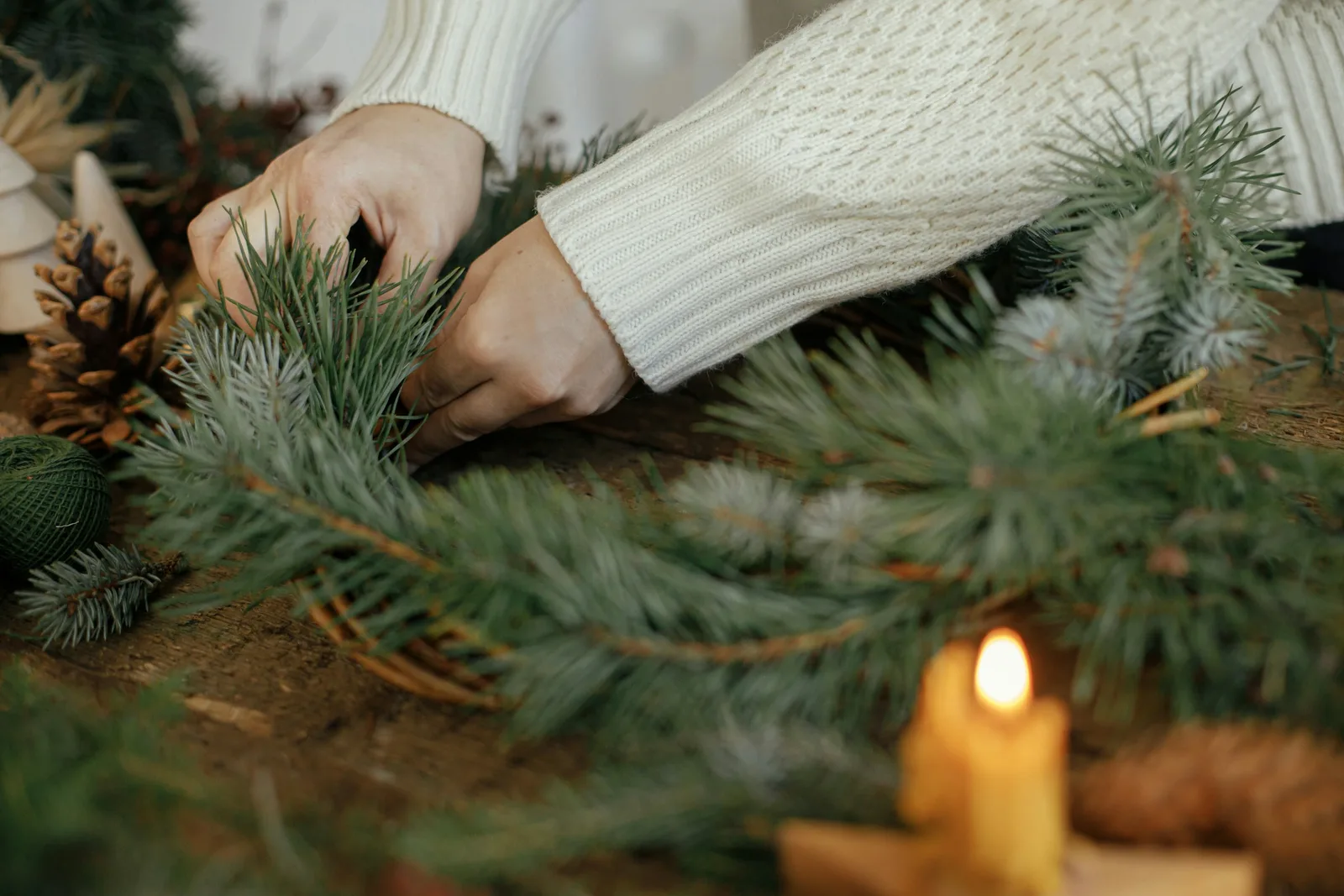 Making a festive wreath with greenery at a Christmas wreath-making workshop