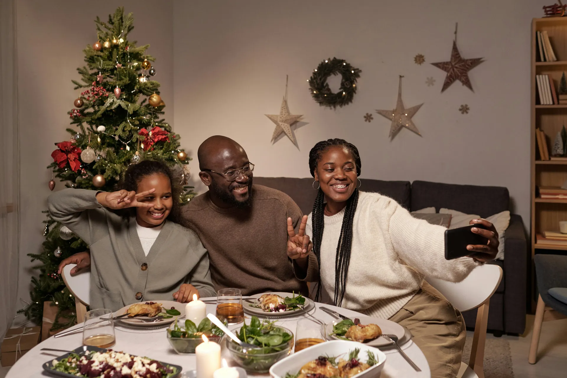 A family cosying up together for a festive film at home on Christmas Eve