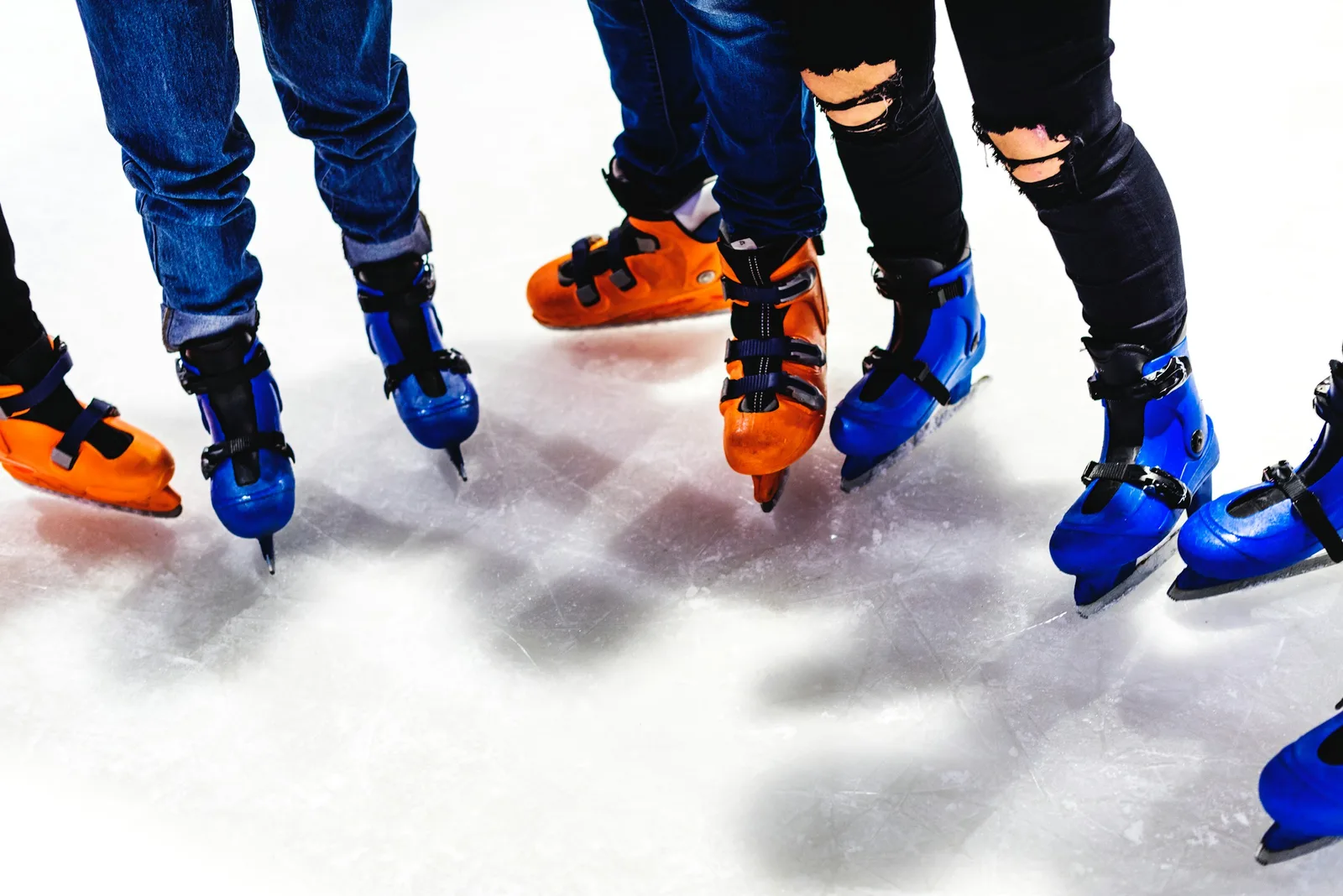 Children and adults ice skating together at a festive rink
